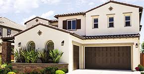 This tuscan style garage door was handcrafted in solid rustic alder wood with an oil rubbed finish and decorative iron hardware. Garage Doors For Homes With Mediterranean Spanish Style And Design