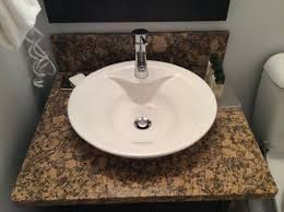 vessel sinks and granite countertops in