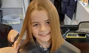 Evie loses locks to help children with cancer