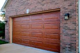 There Is No Question That A Wood Garage Door Will Add A Tremendous Curb Appeal To A Home If You Are T Garage Door Design Garage Door Styles Metal Garage Doors