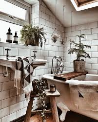 The wood flooring in a raw finish, some indoor plants, and round decorative jute rug complement the wallpaper to bring the boho style to the room. Bohemian Bathroom Accessories Novocom Top