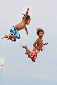 Two Boys Jumping Off Lifeguard S Chair At The Beach Beautiful Children Lifeguard Chair Kids Playing