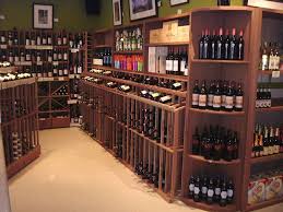 Retail Racking With Custom Pieces Create Custom Adjustable Shelves And Bins To Accent Any Standard Retail Disp Wine Store Design Built In Wine Rack Wine Store