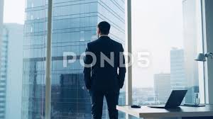 Businessman Looking Out Of Office Window On Big City Stock Footage Ad Window Office Businessman Big Business Man Big Business Office Window