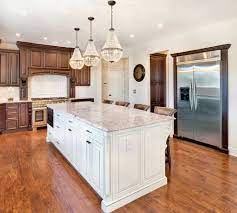 Glossy white kitchen cabinets with medium wood finished breakfast counter. Dark Brown Kitchen With White Island Traditional Kitchen New York By Design Line Kitchens Houzz