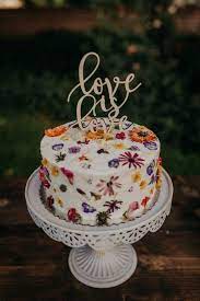 Completely Beautiful Wedding Cake With Edible Wildflowers In The Icing And A Romantic White Metal Cake S Wedding Cake Stands Wildflower Cake Cool Wedding Cakes