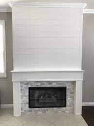 Choose a mix of varying grays or neutrals to make the fireplace. Shiplap And Marble Tile Fireplace Fireplace Surrounds Corner Fireplace Farmhouse Fireplace