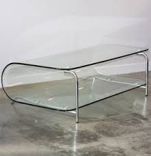 This curved glass coffee table is design and formed from one single sheet of glass where three glass sides are curved down to form legs which gives the table stance and character. Lot Art Modernist Curved Glass Coffee Table