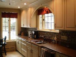 Custom Omega Cabinetry In An Opaque Finish Bumped Out Sink Base And Arched Valance Above Window Kitchen Transformation Kitchen Kitchen Remodel