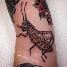 Its main tattoo (or shield or patch) is a complex triangular symbol made out of interlocking arms, with hands grasping lightning bolts and the number 211 in the center. Tattoo Uploaded By Alice Totemica Black Locust Grasshopper Insect Entomology Tattoo Blackworkers Lagtattoos Tunguska Totemica 447072 Tattoodo