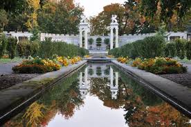 Beyond the unmistakable tree, a parking lot crests at the top of a high stone wall. Untermyer Gardens Restoration Finegardening
