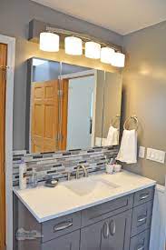 It stops gray water and bathroom products from seeping into the wall. This Contemporary Bathroom Design In A Cool Gray Color Scheme Offers A Relaxing Small Bathroom Makeover Small Bathroom Remodel Tile Backsplash Bathroom Vanity