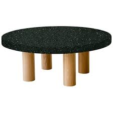 The most common circular coffee table material is metal. Round Emerald Pearl Coffee Table With Circular Oak Legs