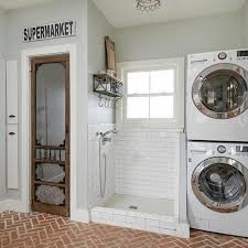 Dog Shower With Shelves And Hanging Hooks Next To Stacked Washer Dryer In 2020 Laundry Room Remodel Mudroom Laundry Room Dream Laundry Room