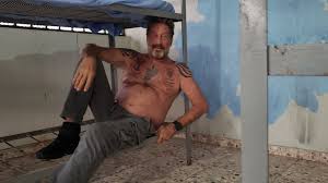 Mcafee had arrived in britain after being detained with his wife for entering the dominican republic with firearms on his yacht. John Mcafee Tweets Photos Of Jail Stay Cnet