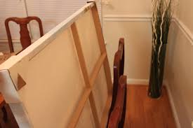 Acrylic coverings with metal posts create a professional and finished frame, often used in art galleries. How To Hang A Canvas Wall Art With Wooden Frame Home Improvement Stack Exchange