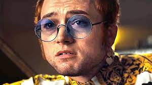 Elton hercules john is a singer and songwriter and the main protagonist in the film rocketman.elton was born reginald kenneth dwight and decided to legally change his name on may 7th, 1972 to elton hercules john.in 1998 elton john was knighted by queen elizabeth ii for his music and media presence. Review Rocketman A Tribute To Legend Elton John Is A Dream Of A Film