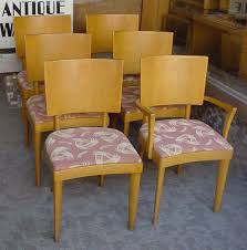 There are 6 chairs with the original fabric and a drop leaf table with 2 leaves. Heywood Wakefield Diningroom Furniture