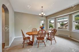 If there is a the commode in the dining room, the carpet should reach to the middle of the space between the chairs and chests of drawers, not underneath it. Beige Dining Room Interior With Round Wall Carpet Floor Wooden Table With Chairs For Six Person Northwest Usa Stock Photo Picture And Royalty Free Image Image 67378593
