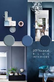 The interior of the bedroom in dark blue with a wide bed, a wooden interior design yellow armchair on blue wall. Blue Interior Trend Paint And Home Decor In Classic Blue Pantone 2020 Trending Decor Interior Trend Interior Design Trends
