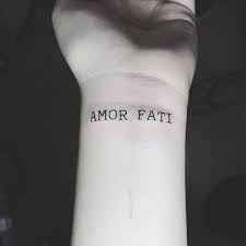 35 Beautiful Amor Fati Tattoo Designs And Meaning Buzz Hippy In 2020 Amor Fati Tattoo Tattoo Designs And Meanings Tattoo Designs