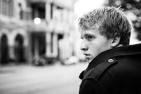 Young Man Walking Alone In The City" by Stocksy Contributor "Geoffrey  Hammond"