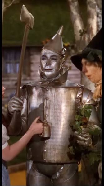 Dorothy (Judy Garland) and the Scarecrow (Ray Bolger) stumble upon a man  made of tin, while walking along the yellow brick road. The Tin Man (Jack  Haley) explains that he has rusted solid, and has no ...