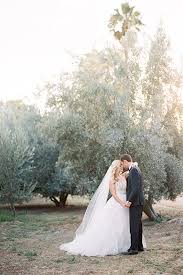 Temecula Outdoor Wedding At The Olive Oil Company Bride Ballgown With Straps And Beaded Bodice With Lace Detail And L Navy Blue Tuxedos Blue Tuxedos Navy Groom