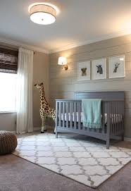 It paints a soothing and calming atmosphere to the room and gets an uplift with the geometric patterns on the walls and fabrics. Beige And Gray Boy Nursery With Beige Shiplap Accent Wall Transitional Nursery Sherwin Williams A Nursery Room Boy Baby Boy Room Nursery Grey Nursery Boy