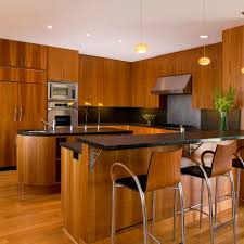 Best backsplash colour for stained wood cabinets add in a gray quarter countertop and some pendant lighting for a really eye catching kitchen look. Photos Hgtv