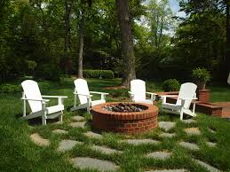 Adirondack Chairs Provide Comfortable Seating Around The Fire Pit Stones With Grass Joints Create Outdoor Fire Pit Outdoor Furniture Sets Fire Pit Furniture