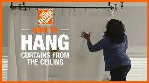 Ceiling drape is a lightweight fabric that is strung decoratively from the ceiling to create a beautiful swag visual effect at weddings and other events. How To Hang Curtains From The Ceiling The Home Depot Youtube
