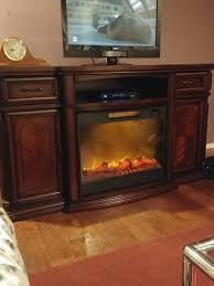 Golden brown woodgrain finish pairs with the metal wire door inserts for a beautiful rustic look. 72 Walnut Electric Fireplace Console Big Lots