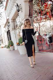 A navy cocktail midi dress with spaghetti straps, white shoes and a white small bag. Fall Wedding Guest Dresses