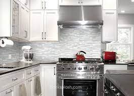 White shaker cabinets are installed on the right wall of the space, aimed to contrast the black countertops and brown subway tile backsplash. Pin On Kitchen