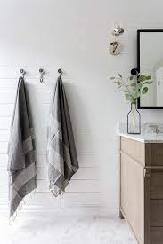 Mounted To A White Tongue And Groove Wall Vintage Towel Hooks Are Fitted Over Marble Like H Bathrooms Remodel Bathroom Interior Design White Bathroom Interior