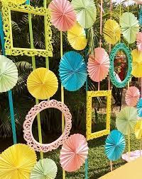 Found This Fun Mehendi Decor With Photo Frames And Paper Fans Were Tempted To Pop Our Head Thro Diy Wedding Decorations Wedding Stage Decorations Mehndi Decor