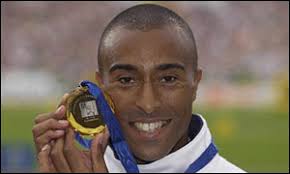 Colin Jackson displays his 110m hurdles gold medal from the 2002 European Championships. Colin Jackson won his fourth European title - _38190519_colin_jackson_medal300