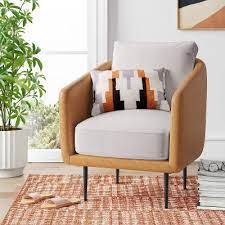 This living room features twin golden rolled arm chairs facing brown floral sofa over a lush, dark wood coffee table. Accent Chairs Target