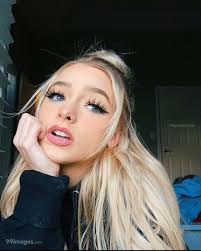 Download A Girl With Long Blonde Hair And Blue Eyes Wallpaper