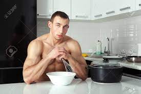 Man In The Kitchen Is Going To Cook. He Bodybuilder With Big Muscles.  Фотография, картинки, изображения и сток-фотография без роялти. Image  38570246