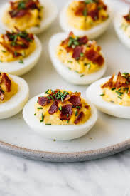 A Plate Of Deviled Eggs With Bacon And Chives Sprinkled On Top In 2020 Bacon Deviled Eggs Egg Recipes Deviled Eggs Recipe