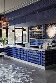 copper and brass metallic vintage lights hang throughout with brass pendants above the main counte cafe interior design modern restaurant design cafe interior