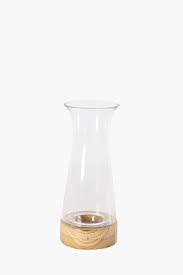 Carefully choosing a home decor vase or hanging planter to match your own home decor is a way to display your good taste. Glass And Wood Tall Vase Vases Shop Decor Home Decor Shop