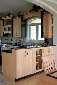 Natural Maple Kitchen Cabinets With Black Accent Trim Pieces And Black Granite Countertops Maple Kitchen Cabinets Maple Kitchen Kitchen Cabinets And Granite