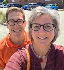 Hello! Let me introduce myself: pictured is my husband, Dietrich and  myself. We have been married 30 years, have 4 children and a dog. Our first  kiddo is getting married April 2026,