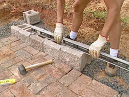 Capstone blocks are typically made to cover the gaps between the blocks in the previous course. How To Build A Block Retaining Wall How Tos Diy