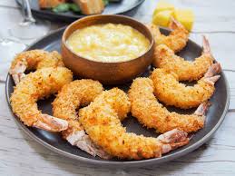 Step 2 hold shrimp by tail, and dredge in flour, shaking off excess flour. Baked Coconut Shrimp With Mango Dipping Sauce Caroline S Cooking