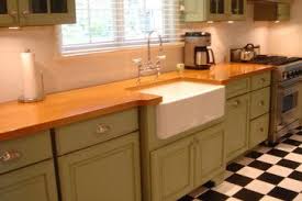 Green cabinets, classic black and white tiled floor