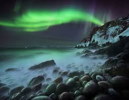 Colorful northern lights with green, red, purple and blue stripes over a beach in iceland. 2020 Northern Lights Photographer Of The Year Capture The Atlas